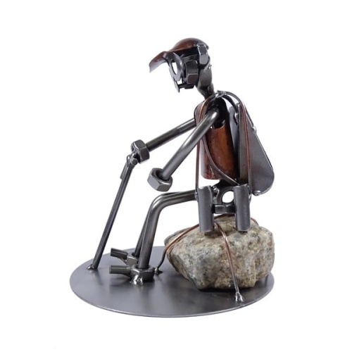 Metalowa figurka Turysta przy kamieniu.